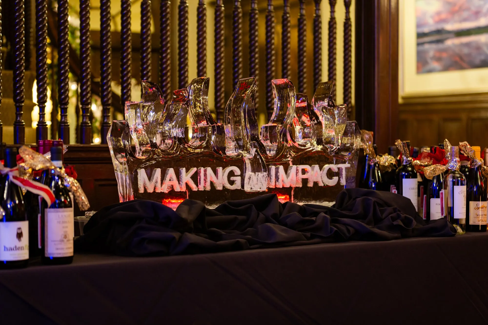 A "Making An Impact" ice sculpture anchors the silent auction table at the Denver Winter Ball